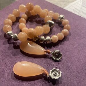 Chicos stretch two bracelets with matching earrings.